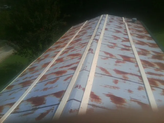 Rusted metal roof panels with new wood purlins before replacement — Storm Damage Roof Repair in Delmar by Roofing Brothers