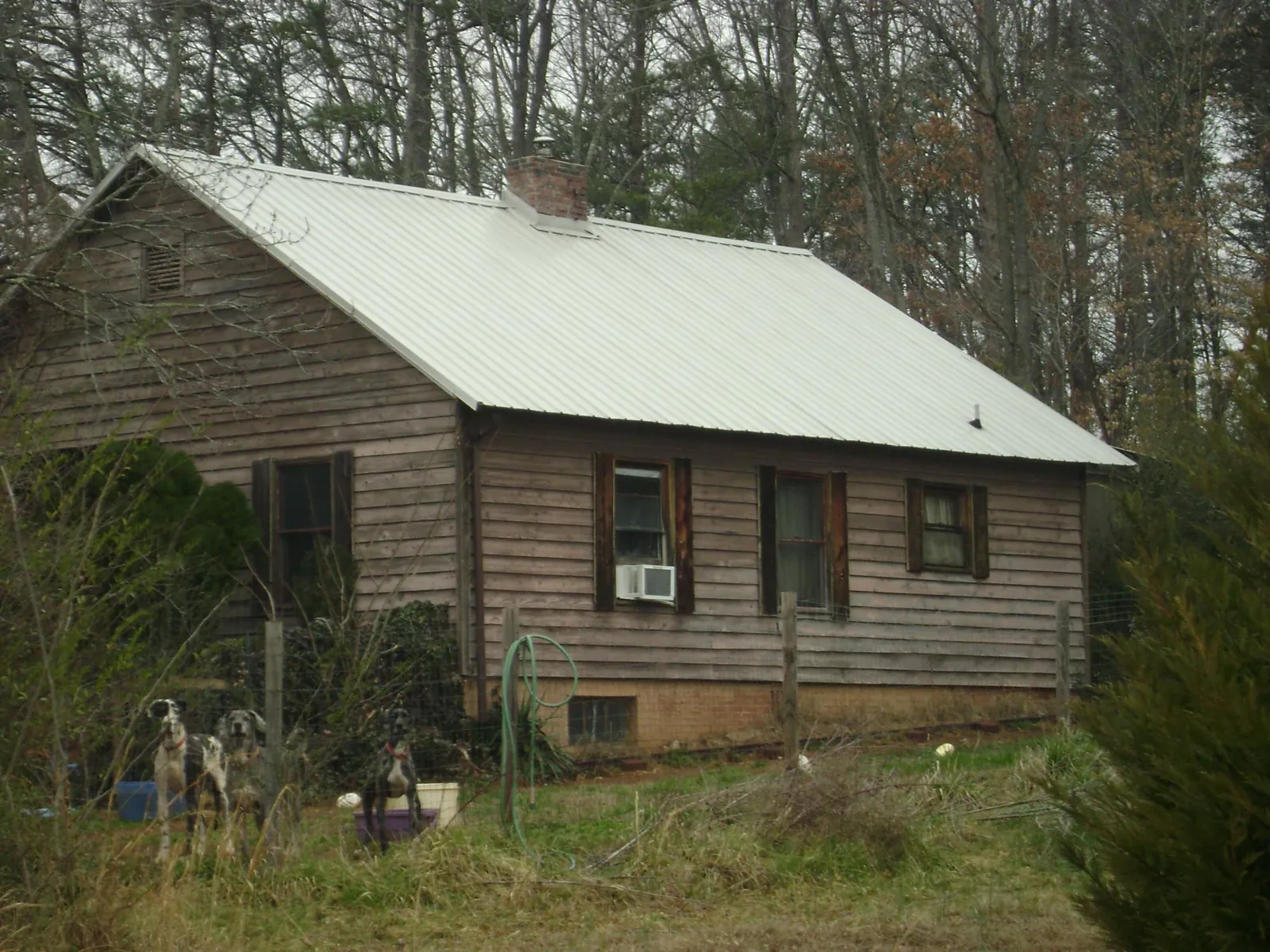 White metal roof on an old wood sided farmhouse, from a Metal Roof Installation job in Delmar